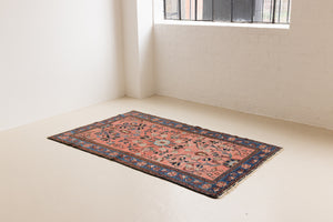 Lilian rugs were handwoven in a small village in Western Iran and often feature floral and geometric patterns as seen here. This small vintage carpet features a soft pink and blue colour palette and an intricate design inspired by nature.