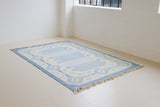 This beautiful vintage Swedish flatweave rug features a stunning blue colour palette and an elegant geometric design.