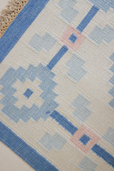 This beautiful vintage Swedish flatweave rug features a stunning blue colour palette and an elegant geometric design.