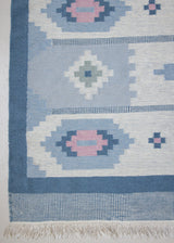 Mason is a vintage rug handwoven in Sweden, featuring a beautiful blue and pink colour palette and a rare large room size