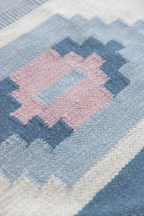 Mason is a vintage rug handwoven in Sweden, featuring a beautiful blue and pink colour palette and a rare large room size.