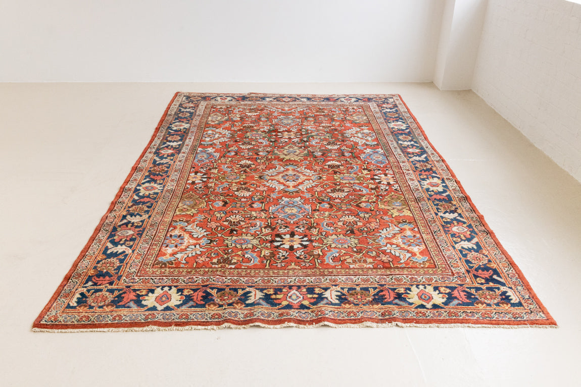 This a Vintage Persian Rug from Mahal in Persia. This hand woven Carpet features a lovely red ground with an all over design.