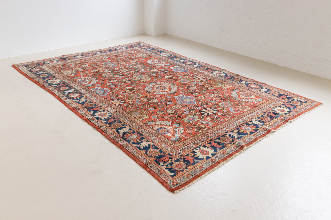 This a Vintage Persian Rug from Mahal in Persia. This hand woven Carpet features a lovely red ground with an all over design.