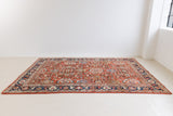 This a Vintage Persian Rug from Mahal in Persia. This hand woven Carpet features a lovely red ground with an all over design.