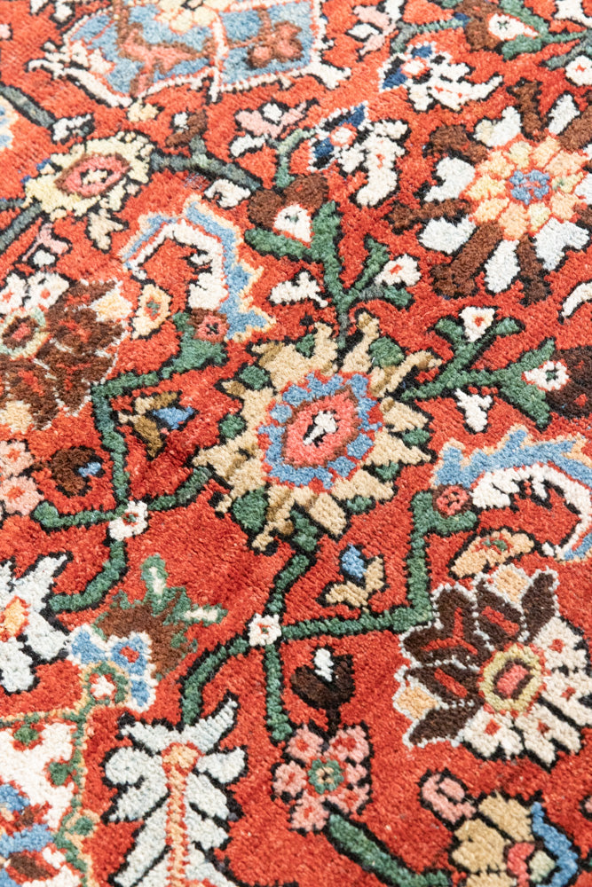 This a Vintage Persian Rug from Mahal in Persia. This hand woven Carpet features a lovely red ground with an all over design.