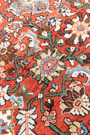 This a Vintage Persian Rug from Mahal in Persia. This hand woven Carpet features a lovely red ground with an all over design.