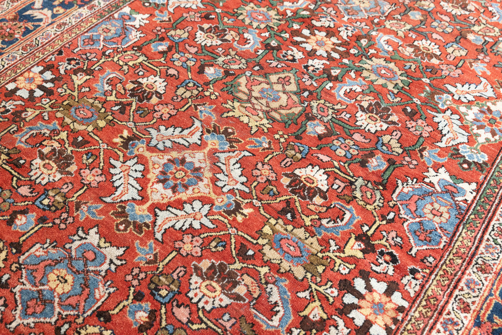 This a Vintage Persian Rug from Mahal in Persia. This hand woven Carpet features a lovely red ground with an all over design.