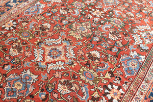 This a Vintage Persian Rug from Mahal in Persia. This hand woven Carpet features a lovely red ground with an all over design.
