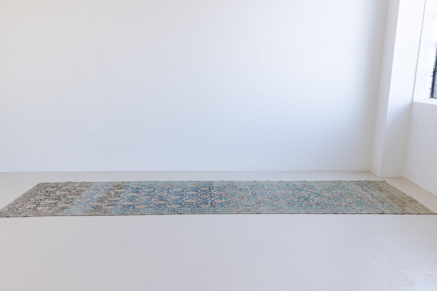 Isabelle is a Persian Malayer runner with a beautiful palette of blues and terracotta softened by a wonderful patina. The antique runner also features the iconic Boteh motif symbolising growth and resilience. 