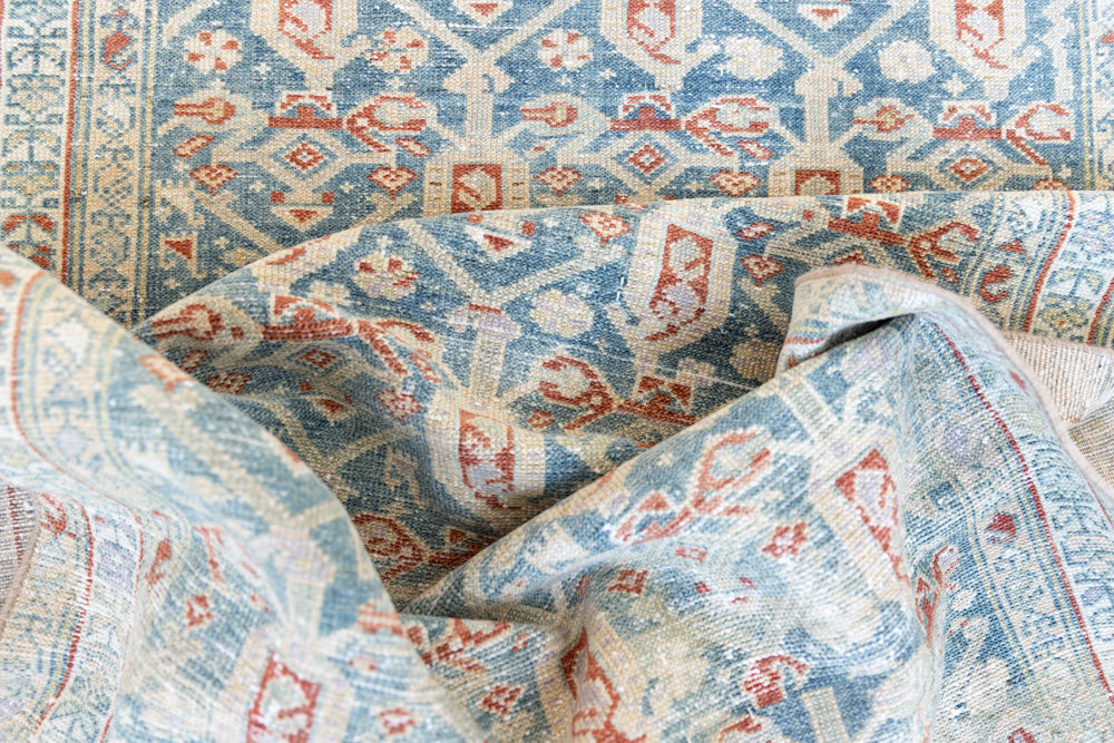 Isabelle is a Persian Malayer runner with a beautiful palette of blues and terracotta softened by a wonderful patina. The antique runner also features the iconic Boteh motif symbolising growth and resilience. 