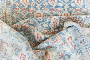Isabelle is a Persian Malayer runner with a beautiful palette of blues and terracotta softened by a wonderful patina. The antique runner also features the iconic Boteh motif symbolising growth and resilience. 