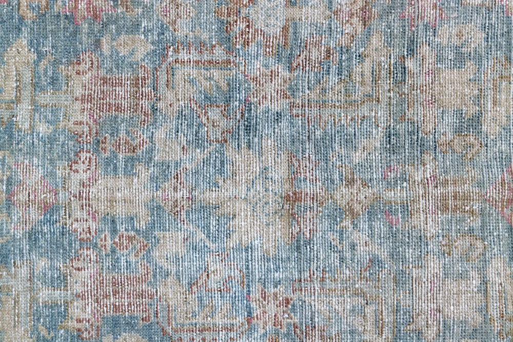 Olive is a Mahal Persian carpet featuring a large central medallion in soft blue and a wide floral boarder with vine scrollwork.