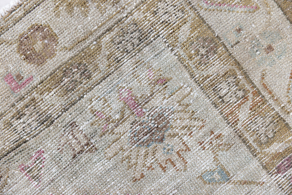 Olive is a Mahal Persian carpet featuring a large central medallion in soft blue and a wide floral boarder with vine scrollwork.