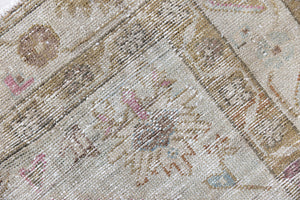 Olive is a Mahal Persian carpet featuring a large central medallion in soft blue and a wide floral boarder with vine scrollwork.