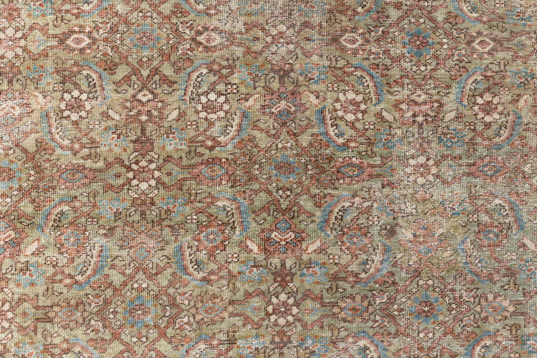 Mahal rugs are some of the most desirable Persian village rugs. This Carpet features an extremely rare pistachio green field and a highly unique floral Herati design 