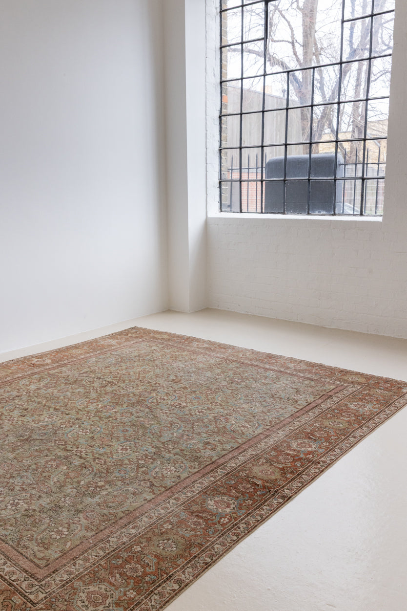 Mahal rugs are some of the most desirable Persian village rugs. This Carpet features an extremely rare pistachio green field and a highly unique floral Herati design 