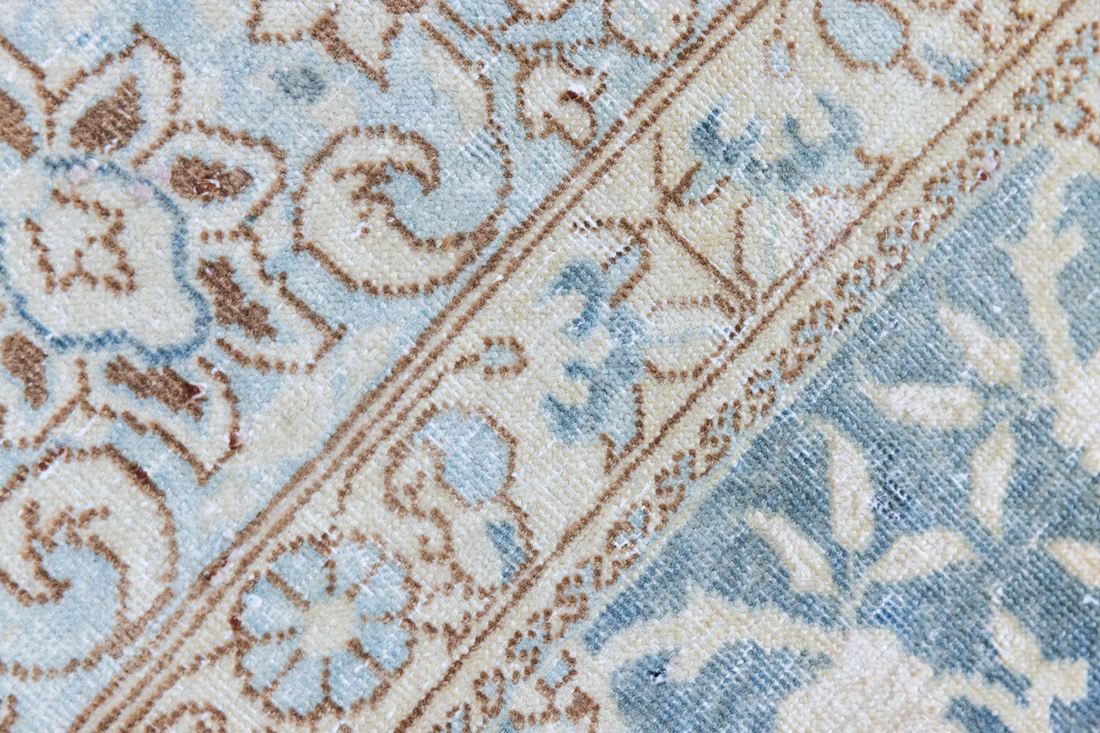 This is a vintage Persian Keshan rug that has been over-dyed to gently fade its original colours, giving a more neutral palette. Persia has the most desirable rugs and carpets with stunning designs such as this carpet. Now available at Ourika London.