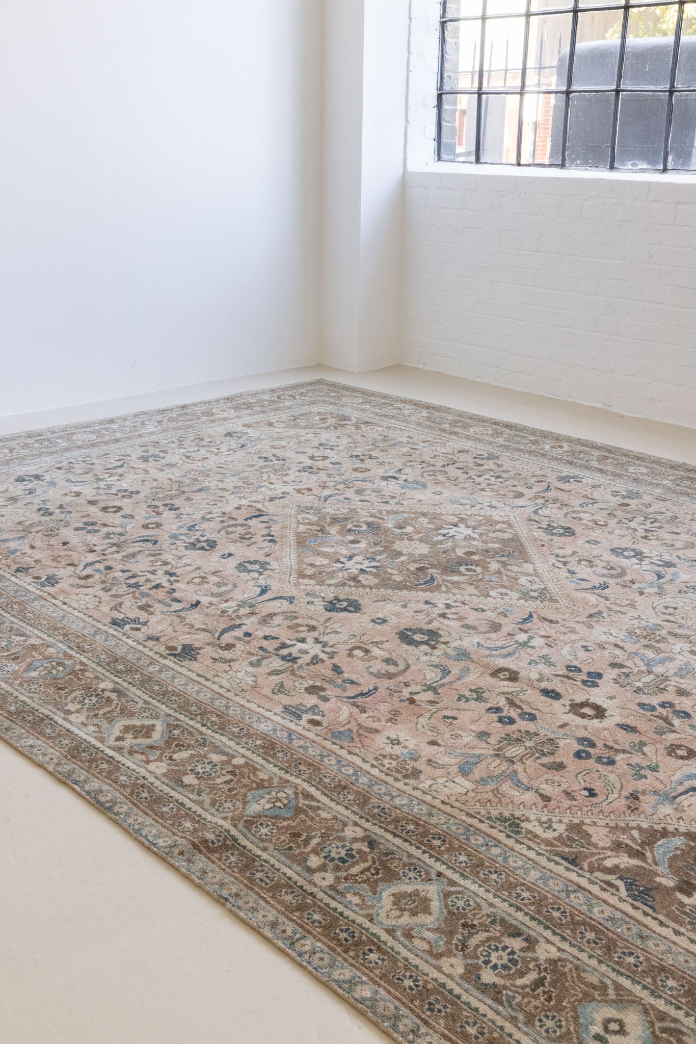 This is a handmade vintage Tabriz rug woven in Persia. The Tabriz region is known for producing some of the most ornate Persian carpet, often known for their mesmerising and intricate repeating patterns.