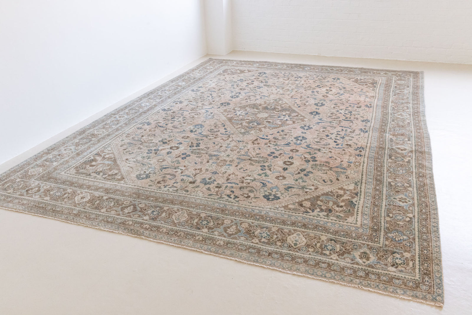 This is a handmade vintage Tabriz rug woven in Persia. The Tabriz region is known for producing some of the most ornate Persian carpet, often known for their mesmerising and intricate repeating patterns.