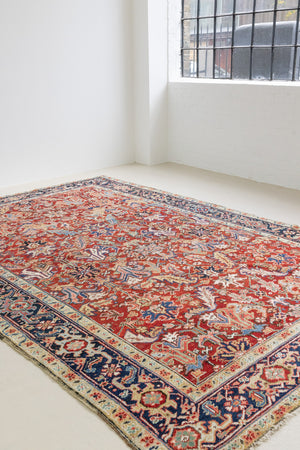 This is a handmade antique Heriz rug woven in Persia. The Heriz region is known for producing some of the most ornate Persian carpet, often known for their mesmerising and intricate repeating patterns.