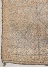 Textured thick pile antique Moroccan rug with a geometric pattern on a peach background