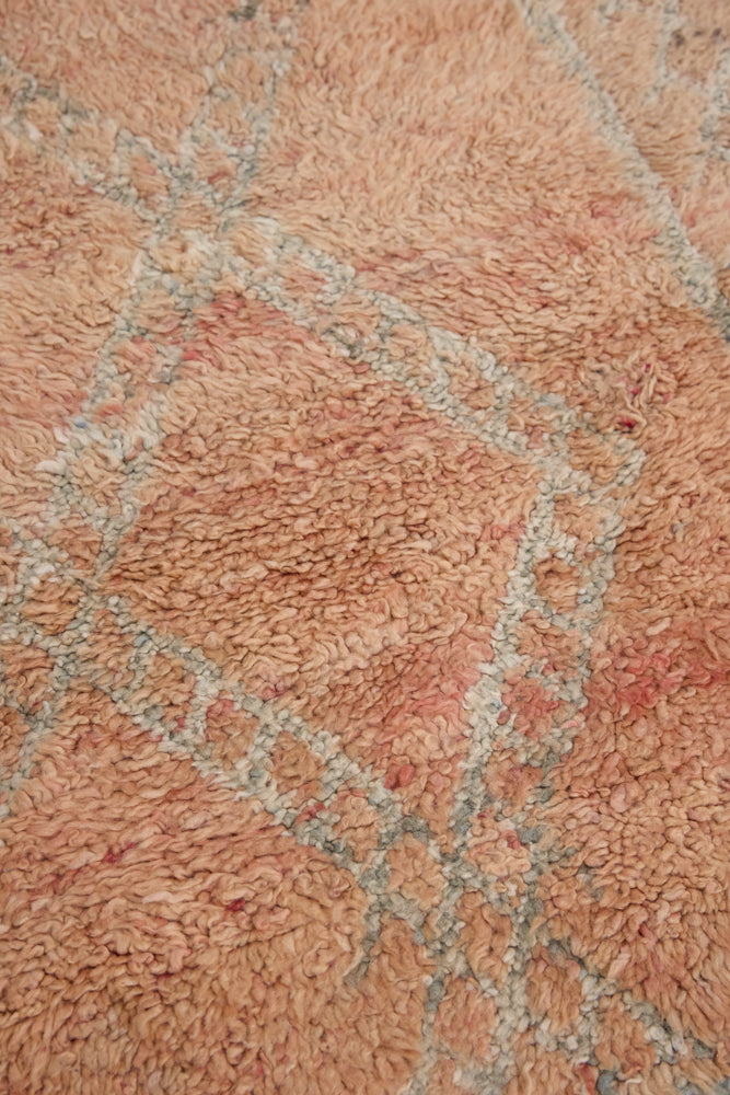 Aliya Beni M’guild vintage thick pile carpet. Peach coloured with a grey geometric pattern.