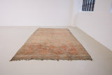 Aliya Beni M’guild vintage thick pile carpet. Peach coloured with a grey geometric pattern.
