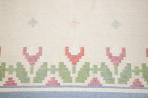 This is an original Swedish röllakan rug handwoven by the mid-century textile designer Anna Johanna Angström. Her colourful kilims often feature strong lines and designs inspired by floral and botanical motifs