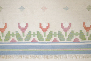This is an original Swedish röllakan rug handwoven by the mid-century textile designer Anna Johanna Angström. Her colourful kilims often feature strong lines and designs inspired by floral and botanical motifs