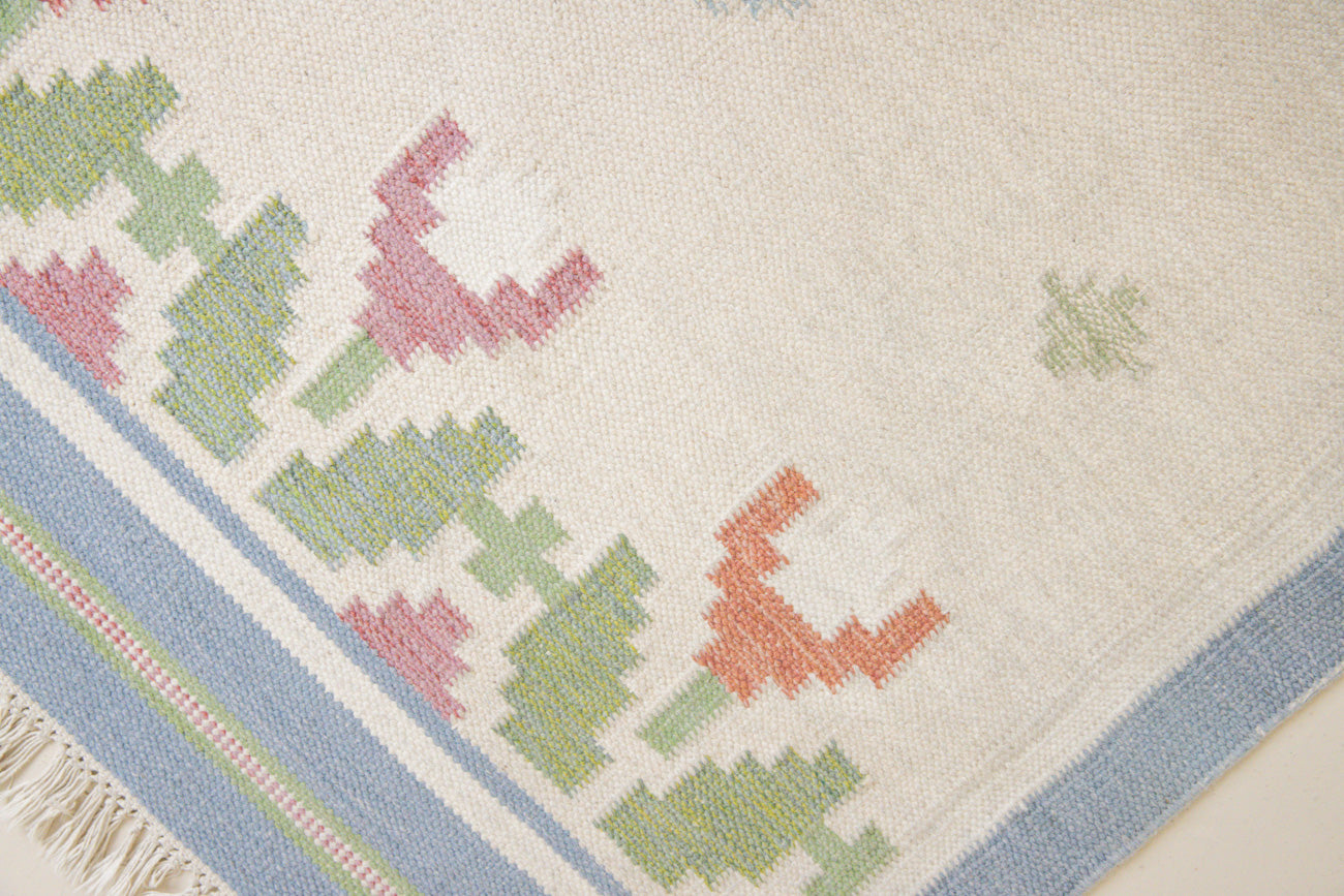 This is an original Swedish röllakan rug handwoven by the mid-century textile designer Anna Johanna Angström. Her colourful kilims often feature strong lines and designs inspired by floral and botanical motifs