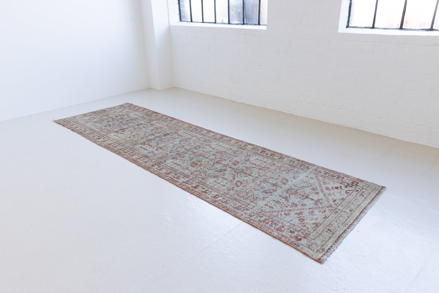 Sage is a Persian Malayer runner with a beautiful palette of blues and terracotta and a wonderful patina. The Malayer region is known for producing some of the most ornate Persian rugs, often known for their mesmerising and intricate repeating patterns.