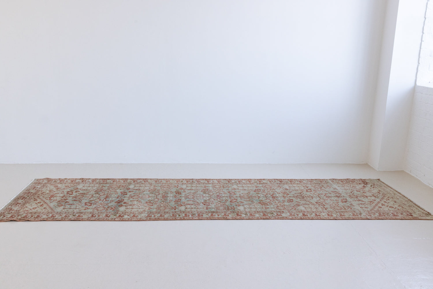 Sage is a Persian Malayer runner with a beautiful palette of blues and terracotta and a wonderful patina. The Malayer region is known for producing some of the most ornate Persian rugs, often known for their mesmerising and intricate repeating patterns.