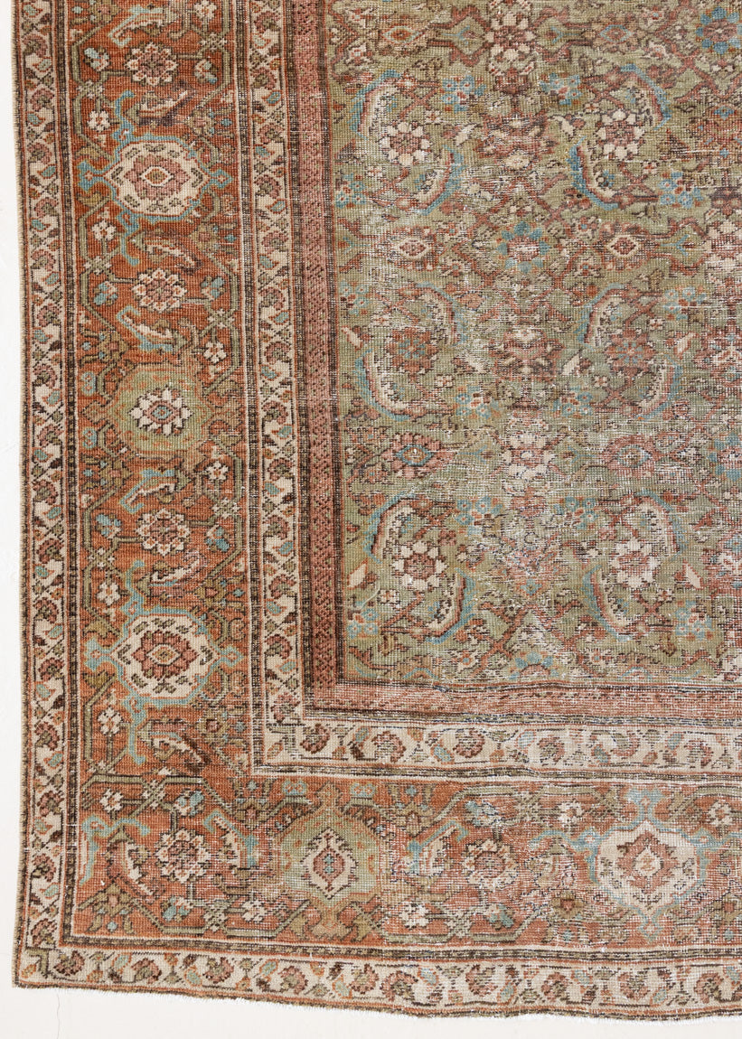 Mahal rugs are some of the most desirable Persian village rugs. This Carpet features an extremely rare pistachio green field and a highly unique floral Herati design 