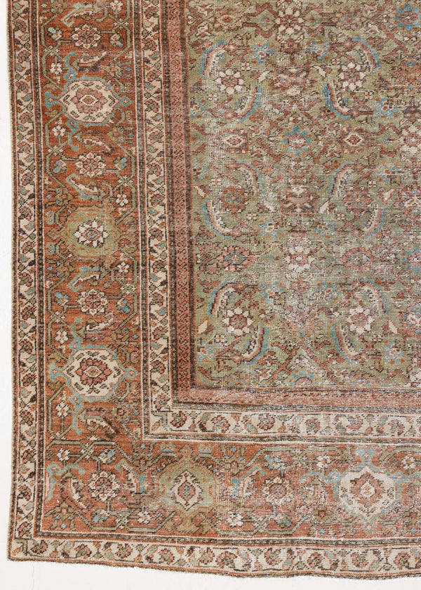 Mahal rugs are some of the most desirable Persian village rugs. This Carpet features an extremely rare pistachio green field and a highly unique floral Herati design 