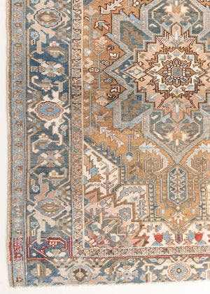 This is a vintage Persian Heriz rug. With a unique antique wash, this carpet boasts a muted palette in soft blue with flashes of red and brown