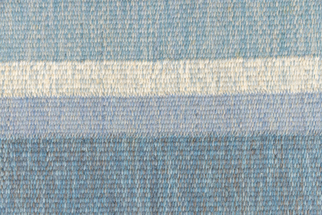 Ingo is a vintage rug handwoven in Sweden by textile designer Ingegerd Silow. Featuring a floral geometric pattern in blues. greens. pinks and black.