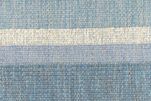 Ingo is a vintage rug handwoven in Sweden by textile designer Ingegerd Silow. Featuring a floral geometric pattern in blues. greens. pinks and black.