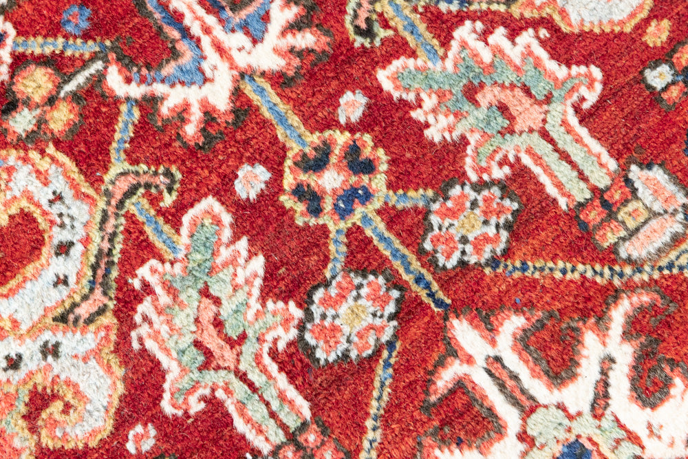 This is a handmade antique Heriz rug woven in Persia. The Heriz region is known for producing some of the most ornate Persian carpet, often known for their mesmerising and intricate repeating patterns.