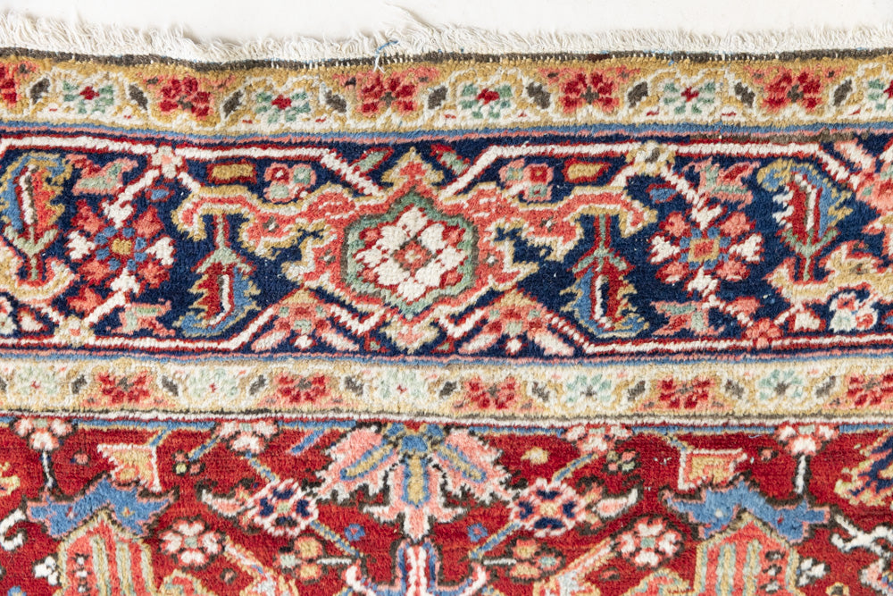 This is a handmade antique Heriz rug woven in Persia. The Heriz region is known for producing some of the most ornate Persian carpet, often known for their mesmerising and intricate repeating patterns.