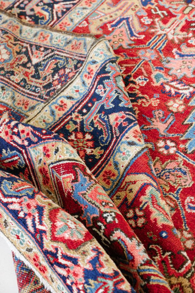 This is a handmade antique Heriz rug woven in Persia. The Heriz region is known for producing some of the most ornate Persian carpet, often known for their mesmerising and intricate repeating patterns.