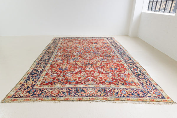 This is a handmade antique Heriz rug woven in Persia. The Heriz region is known for producing some of the most ornate Persian carpet, often known for their mesmerising and intricate repeating patterns.