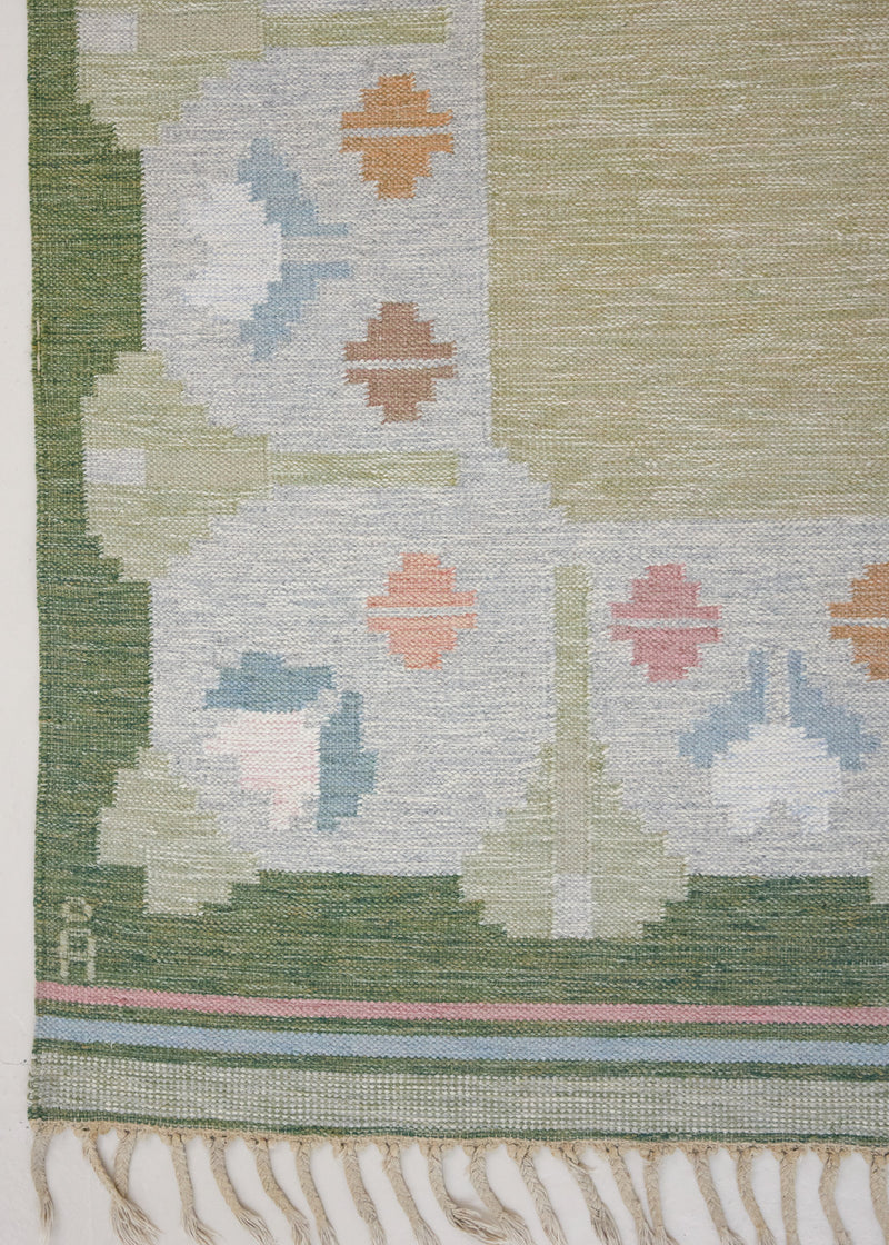 Trudie is an original Swedish röllakan rug handwoven by mid-century textile designer Anna Johanna Angström. Green colour-way featuring floral motifs 