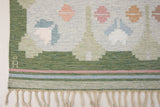 Trudie is an original Swedish röllakan rug handwoven by mid-century textile designer Anna Johanna Angström. Green colour-way featuring floral motifs 