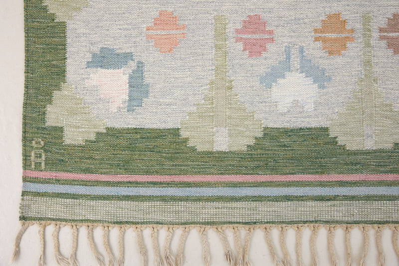 Trudie is an original Swedish röllakan rug handwoven by mid-century textile designer Anna Johanna Angström. Green colour-way featuring floral motifs 