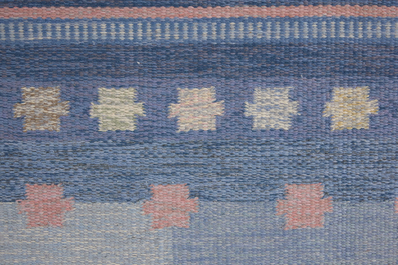 an original Swedish röllakan rug handwoven by mid-century textile designer Anna Johanna Angström. Her colourful kilim features strong lines in a blue and pale blue checkered pattern with accents of pink and cream