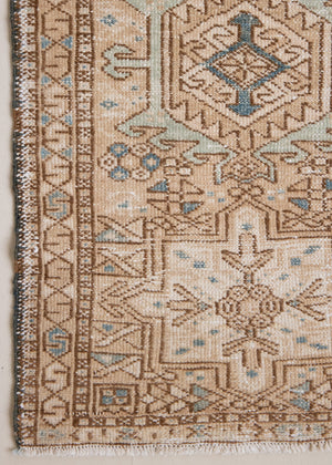Bonnie is an vintage Persian Heriz runner rug which has been antique washed using a special technique to gently fade its original colours, creating a stunning muted palette. Heriz rugs are some of the most sought after Persian carpets and this one features a classic Heriz design in gorgeous soft blue, taupe and cream tones. 