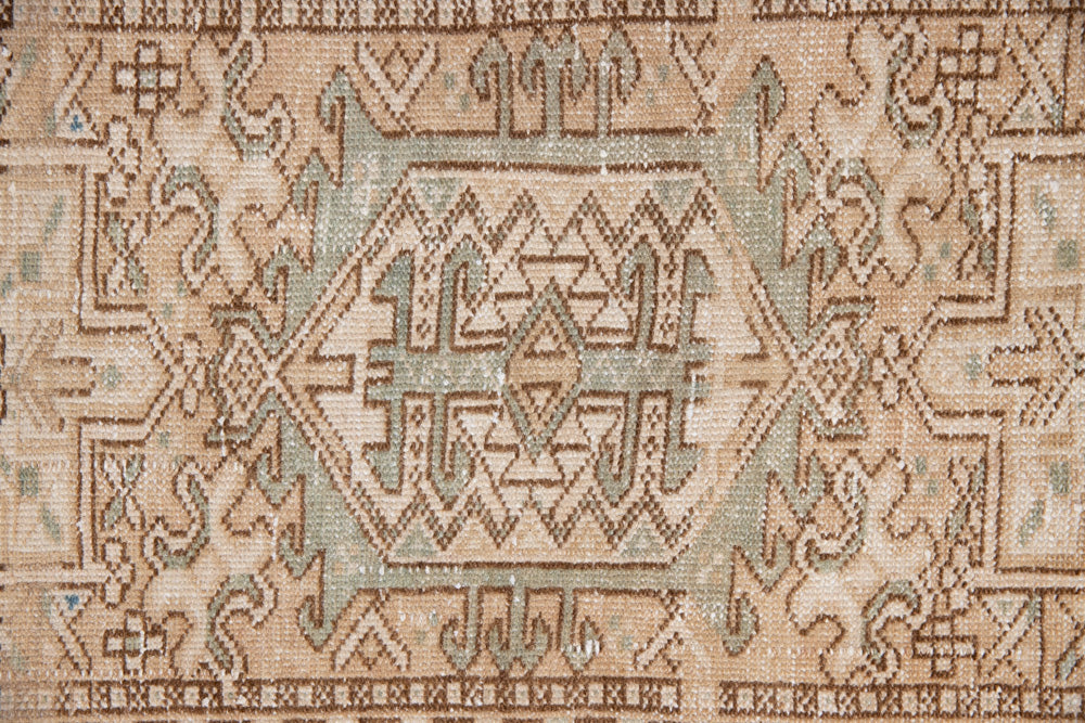 Bonnie is an vintage Persian Heriz runner rug which has been antique washed using a special technique to gently fade its original colours, creating a stunning muted palette. Heriz rugs are some of the most sought after Persian carpets and this one features a classic Heriz design in gorgeous soft blue, taupe and cream tones. 