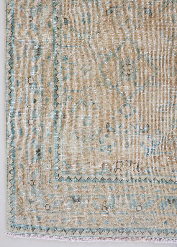 This vintage hand knotted Persian long rug comes from the Tabriz region, one of the oldest rug weaving centres in the world. This beautiful rug features a calming blue and taupe colour palette and a stunning all over design.