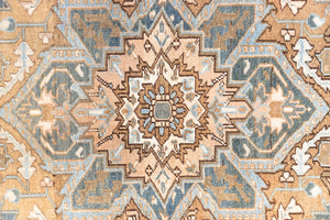 This is a vintage Persian Heriz rug. With a unique antique wash, this carpet boasts a muted palette in soft blue with flashes of red and brown