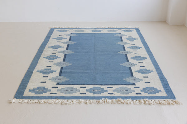 Handwoven vintage Swedish rug with a geometric pattern in blue and ivory